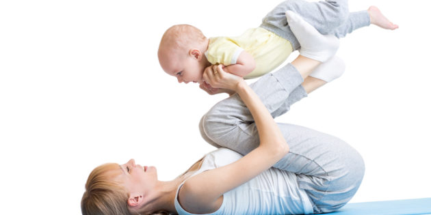 happy mother and baby making healthy fitness exercises